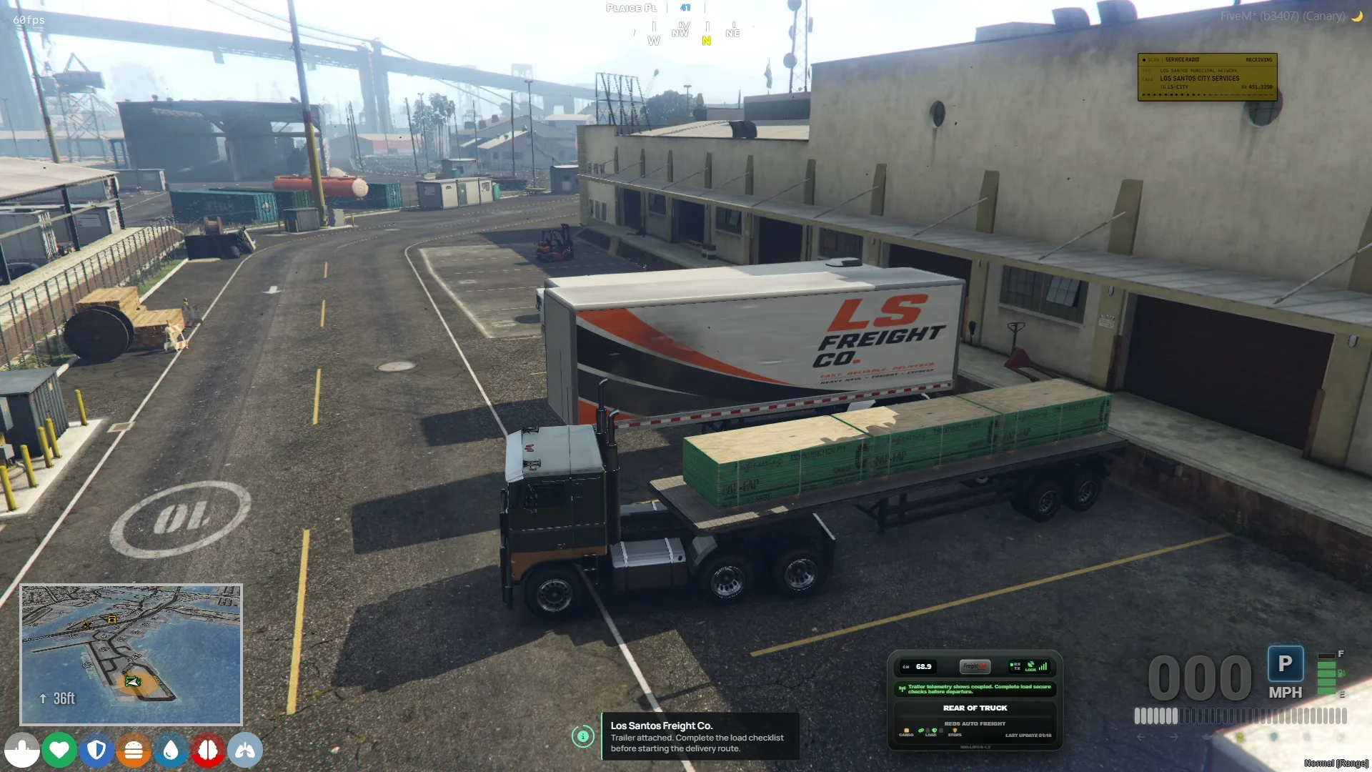 Jobuilt Hauler attached to a loaded flatbed trailer at the freight depot.