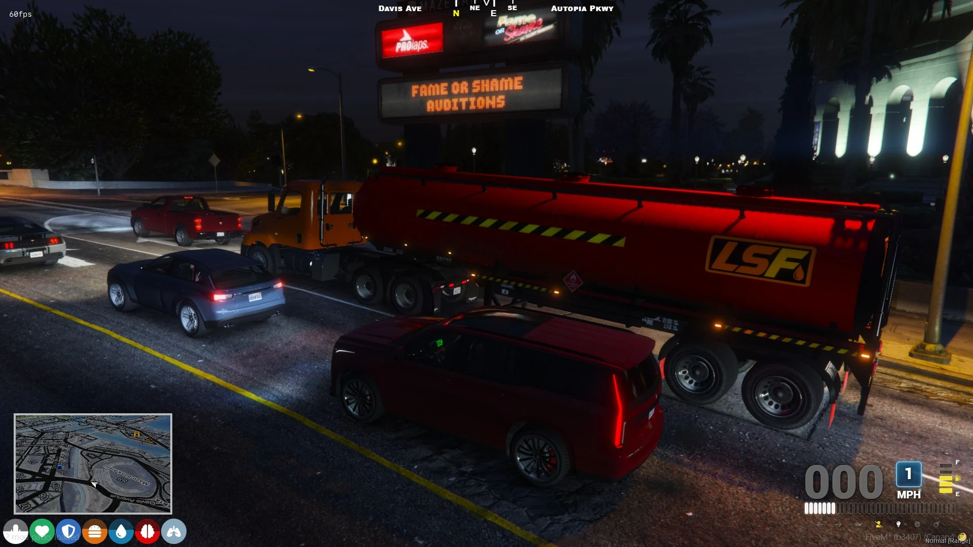 Red LS Freight fuel tanker operating in nighttime city traffic.