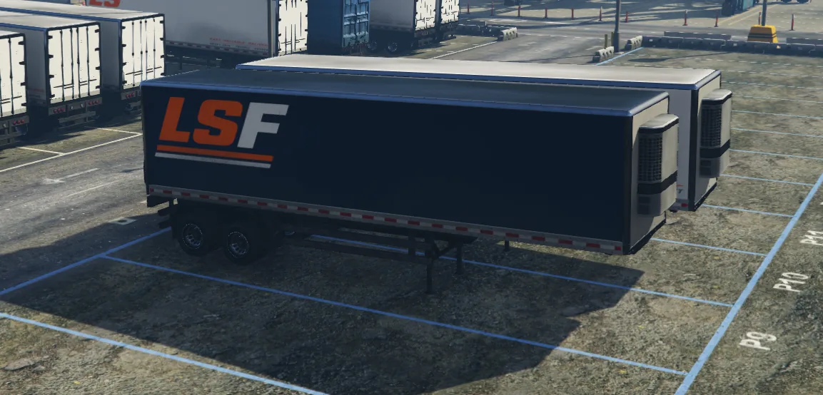 Two black LS Freight refrigerated trailers with orange-and-white branding.